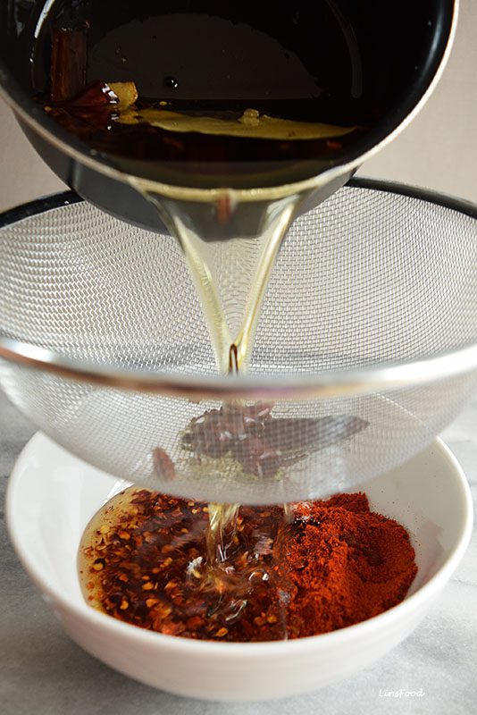 Pouring hot oil on chilli flakes in Sichuan Chilli Oil